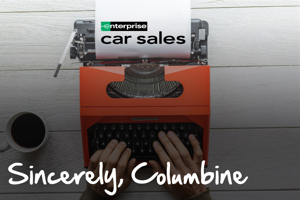 Person typing on an old typewriter with logo of Enterprise Car Sales and a heading that reads "Sincerely, Columbine"