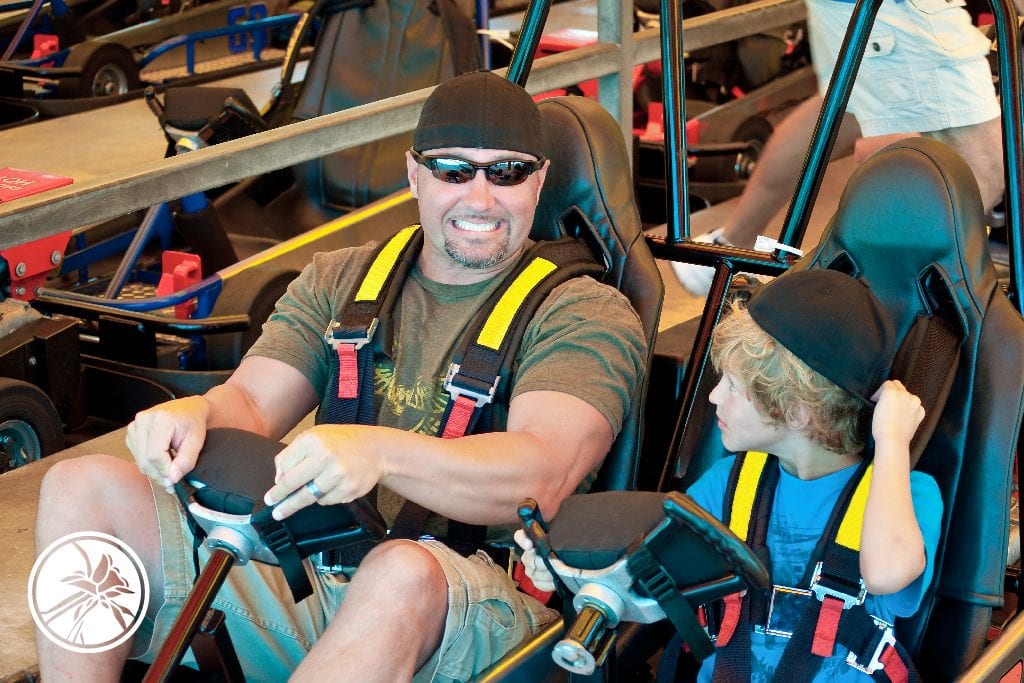 Father and son sitting in gocarts