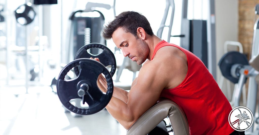 man at the gym lifting a weight bar