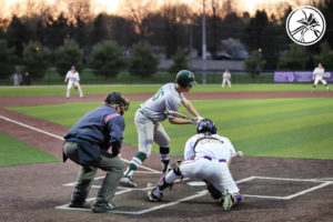people playing baseball, one guy in action about to hit a baseball