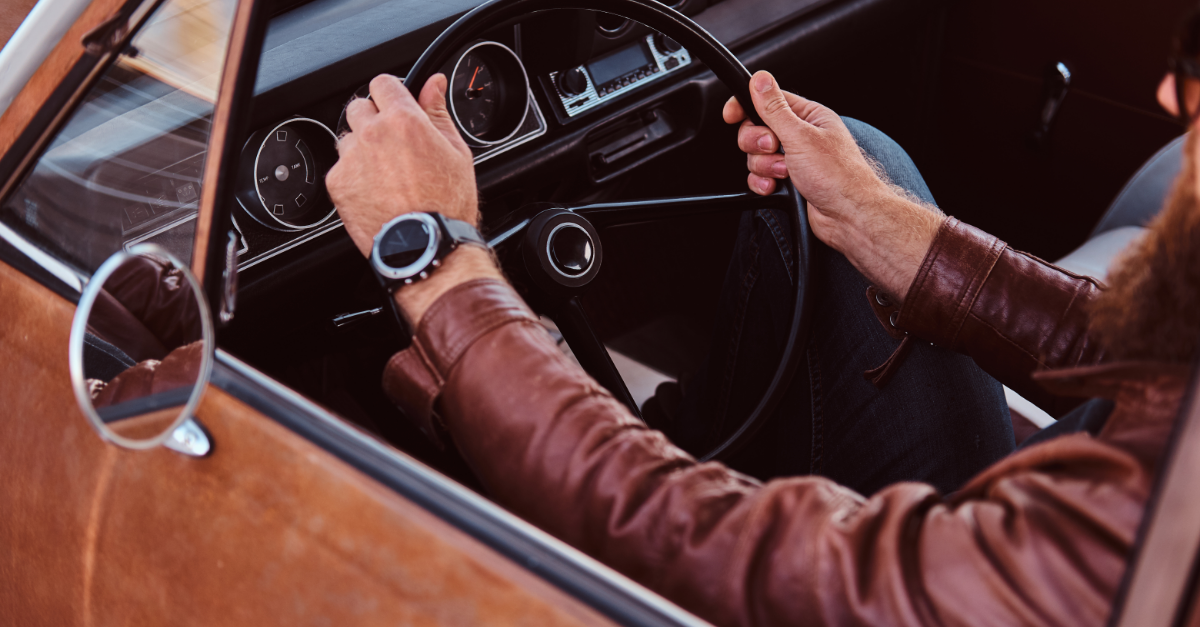 bearded man in leather and sunglasses driving a car very cool