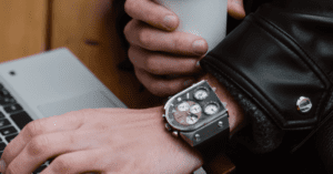 man wearing a leather jacket with cool watch and coffee