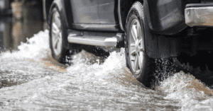 truck driving through a flooded street