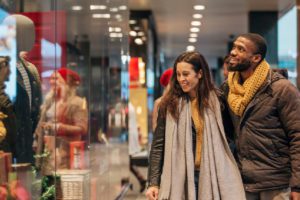 couple window shopping dressed for cold weather
