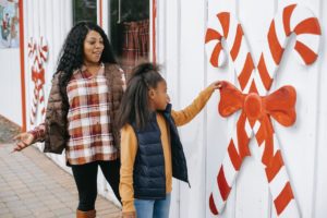 mother and daughter shopping daughter distracted by giant candy cane