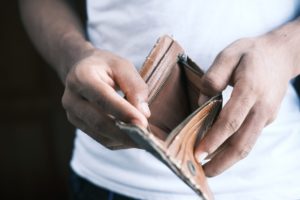 person looking into an empty wallet