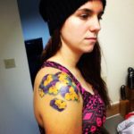 floral shoulder tattoo in purple and yellow pansy