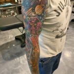 space-themed sleeve tattoo