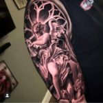 religious looking statue tattoo