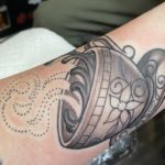 intricate tattoo of a tea cup with steam