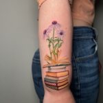 stack of books and flowers tattoo