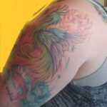 very colorful watercolor bird tattoo