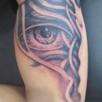 tattoo of musculature with eye peeking through