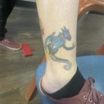 ankle tattoo of a dragon