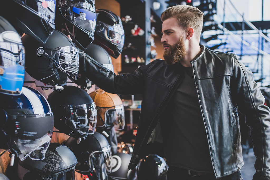 styled man looking at helmets with live a little