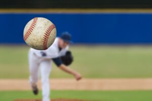 Image of a baseball pitcher throwing a baseball.