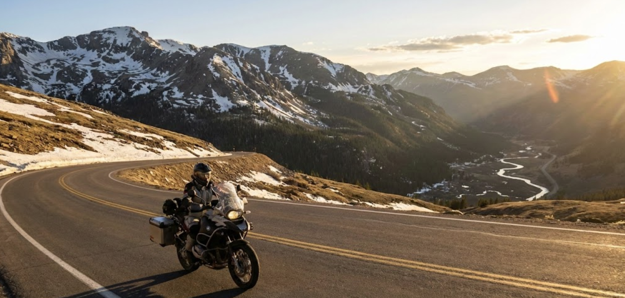 Motorcycle riding on Colorado mountain highway with Rocky Mountain views